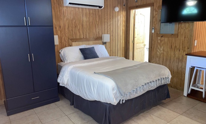 Porum Cabin | Studio cabin #3 with lake view and boat dock access, outdoor seating.