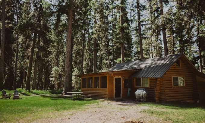 Seeley Lake Cabin | The Saddle Shed at Tamaracks Resort is a log cabin with furnished screen porch.