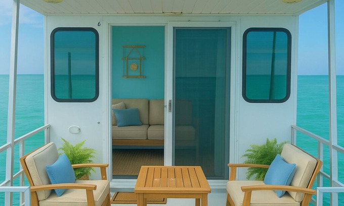 George Town Boat Rental | Water Glamping over turquoise blue water.