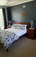 Fannie Bay House | Fannie Bay - Queen bedroom with resort pool
