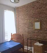 Bedford-Stuyvesant Apartment | Beautiful room with a brick wall