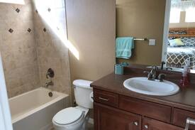 Vista Ridge House | Mountain Views! Bedroom with private bathroom.