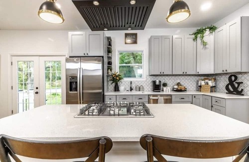 Mickleton House | Embrace the charm of our creekside haven featuring 4BR 3BA yoga and BBQ deck.