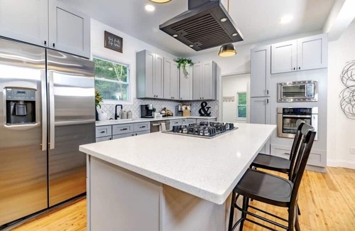 Mickleton House | Embrace the charm of our creekside haven featuring 4BR 3BA yoga and BBQ deck.