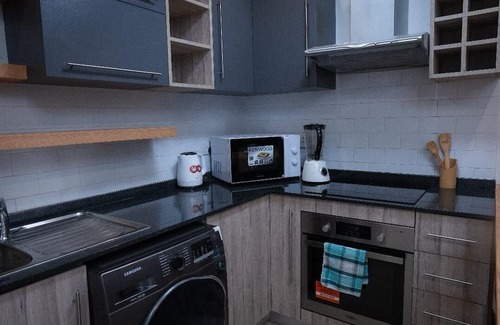 East Legon Apartment | Chic 1-bedroom apartment with fitness room and AC in vibrant Accra