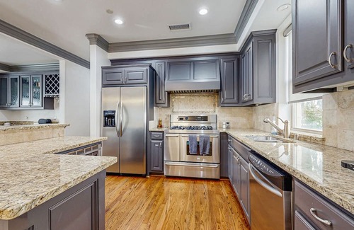 Oak Lawn Condo | Modern Dallas home with spacious living room, kitchen & big patio with city view