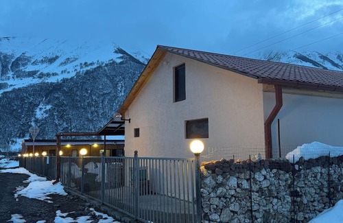 Kazbegi House | A Private Guest House in a secluded area by the river, surrounded by mountains.